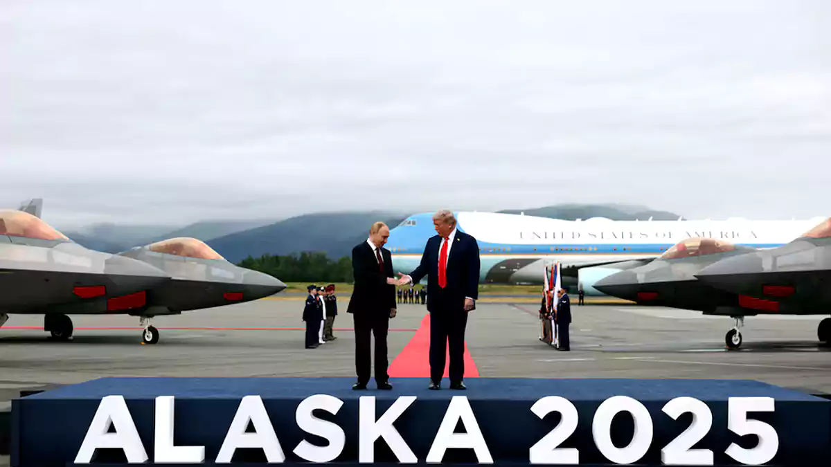 Donald Trump shakes hands with Russian President Vladimir Putin as they meet to negotiate an end to the war in Ukraine